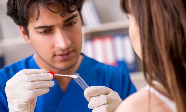 Doctor getting saliva test sample in clinic hospital