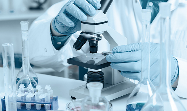 men in a laboratory with microscope 