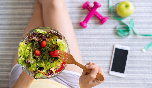 woman eating homemade healthy salad at home
